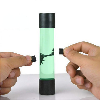 Venom symbiote ferrofluid kit with a green liquid in a cylindrical container and two black magnets held by hands.