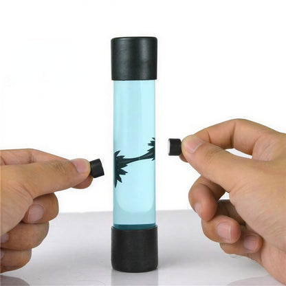 Venom symbiote ferrofluid kit with a clear tube, black caps, and hands manipulating the fluid inside.