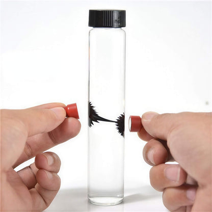 Venom symbiote ferrofluid kit with a clear test tube and magnetic red caps, showcasing fluid movement inside.