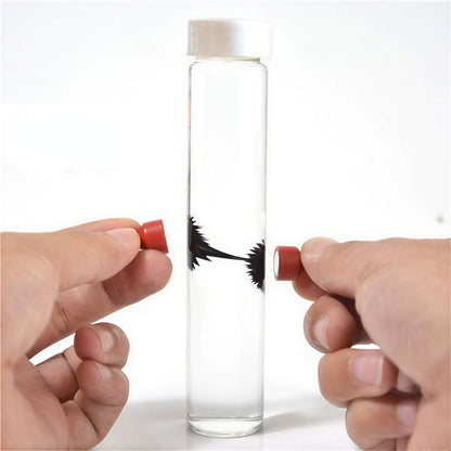 Venom symbiote ferrofluid kit with a clear test tube and red magnetic caps, showcasing fluid movement inside.